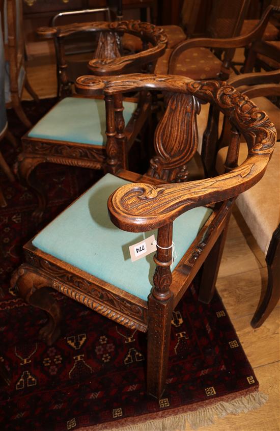 A pair of late 19th century carved oak corner chairs